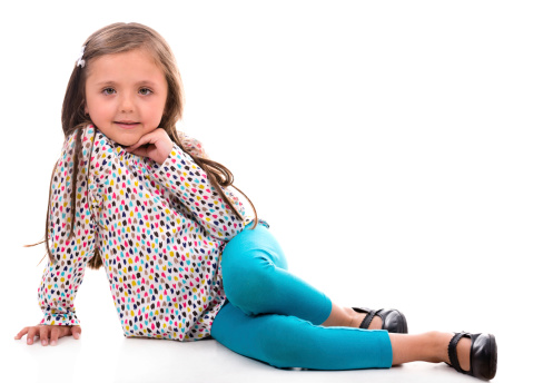 Beautiful little girl posing at the camera. Isolated over white background