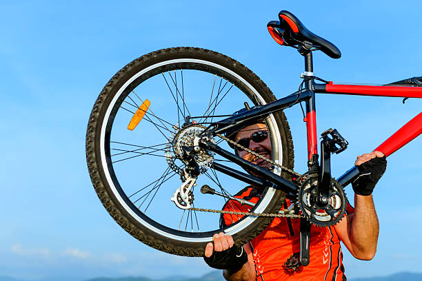 istock man raising bike 180827678