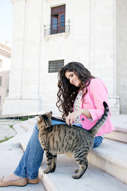 istock Young woman with digital tablet and cat 180827692