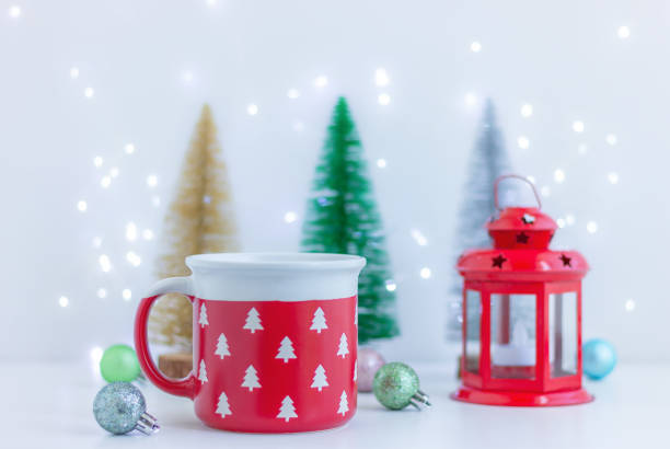 istock Christmas festive decor and red cup with pattern of white fir trees on table. decorations, celebration, winter holiday 1808279189