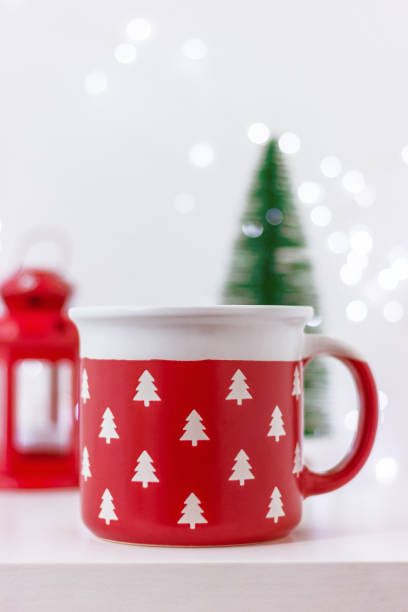 istock close up large red cup with pattern of white Christmas trees on table. celebration, winter holiday 1808279191