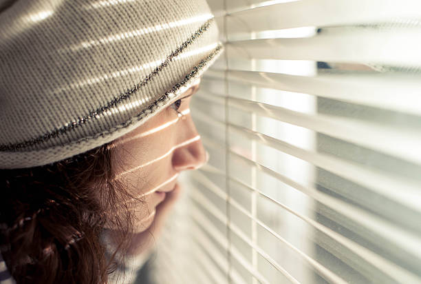 Looking through... Girl looking through window neighborhood crime watch stock pictures, royalty-free photos & images