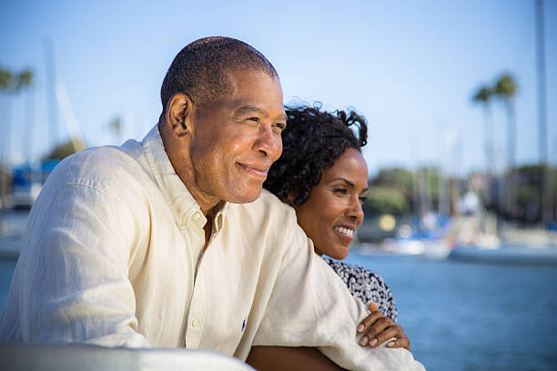 istock Smiling Couple Look Out on a Marina 180828325
