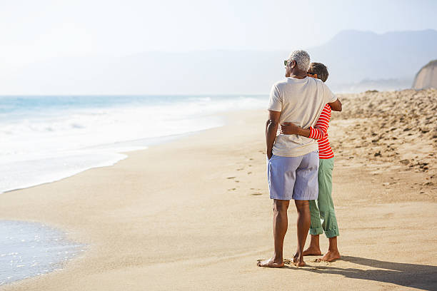 istock Senior African American couple embracing on beach 180828577