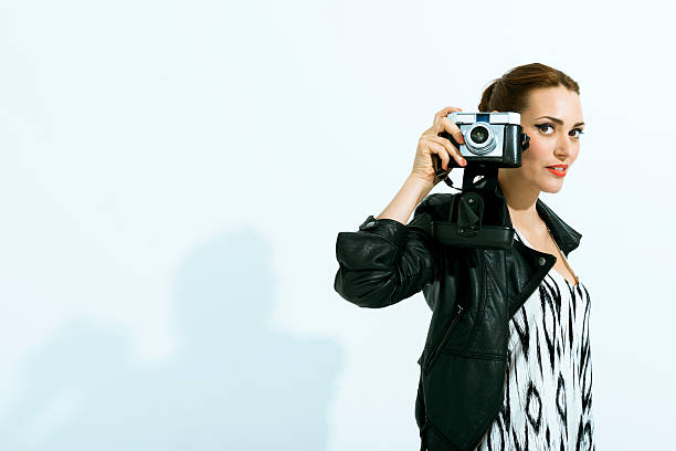 istock Stylish fashion model holding a retro camera 180829090