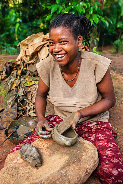 Young Ethiopian woman making pottery in the village in Omo Valley.