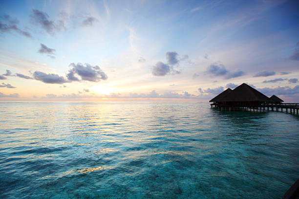 istock maldivian houses on sunrise 180829365