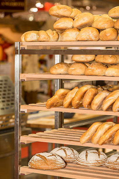 istock Freshly baken bread cooling on trays in a bakery 180829612
