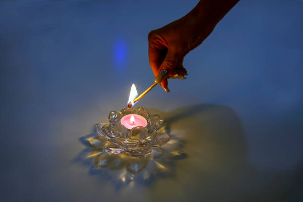 lighting a candle in a beautiful candlestick