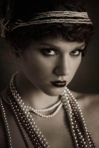 Retro woman portrait. Beautiful Girl in 20s or 30s Style. Old Fashionable Finger Wave Makeup and Hairstyle.