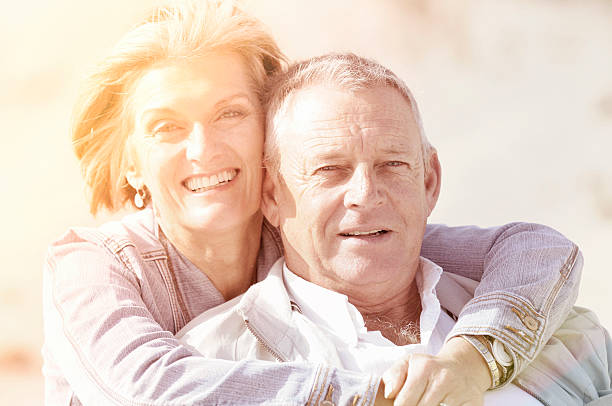 istock Smiling senior couple with sun flare 180830333