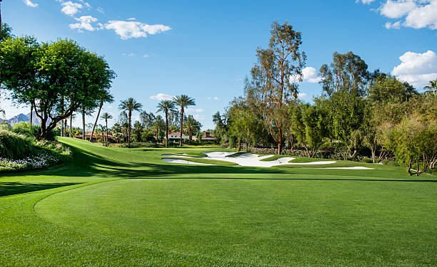 California Golf "A putting green and sand traps on a  luxury golf course in La Quinta, California." country club stock pictures, royalty-free photos & images