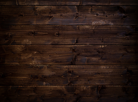 Wooden floor made of dark textured boards.