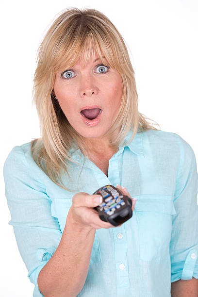 istock woman with television remote 180830573