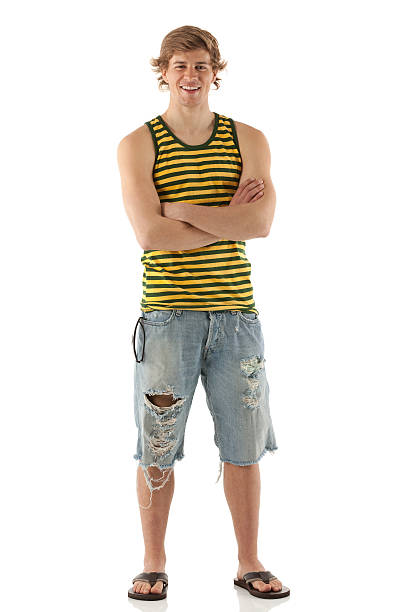 Young smiling man standing with arms crossed