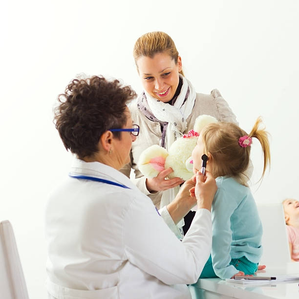 istock Mother and her daughter during visit at the doctor's office. 180832463
