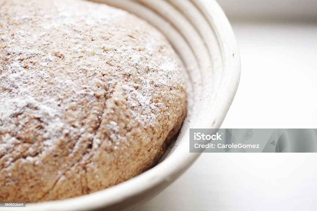 Dough Rising in a Banneton Home made sourdough left to prove in a traditional cane banneton. Basket Stock Photo