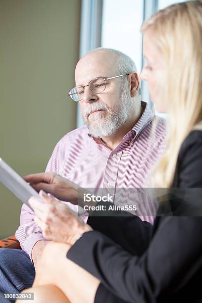 Social Worker Working With Senior Man On Digital Tablet Stock Photo - Download Image Now