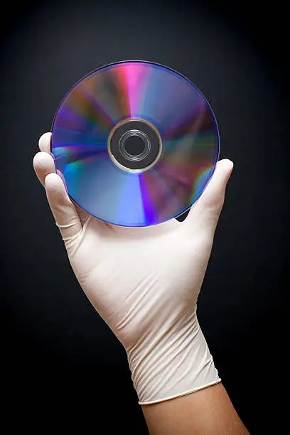 Holding a disk isolated on black background