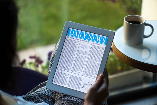 istock Woman reading news on tablet pc 180833731