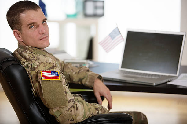 American Soldier in his office Handsome American soldier in his office - looking at the camera. national guard stock pictures, royalty-free photos & images