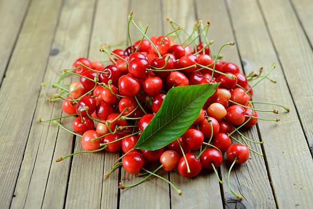 istock Ripe cherries on wooden old table 180834527