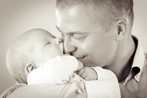 istock Baby licking fathers' nose 180834653