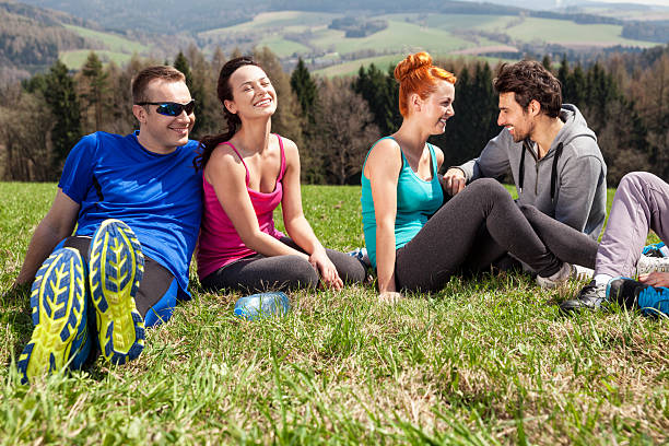 istock Friends Sitting On Meadow 180834874