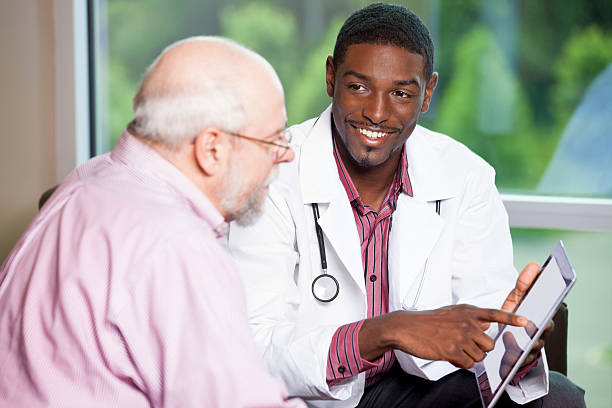 istock Doctor explaining treatment results to senior man on digital tablet 180834947