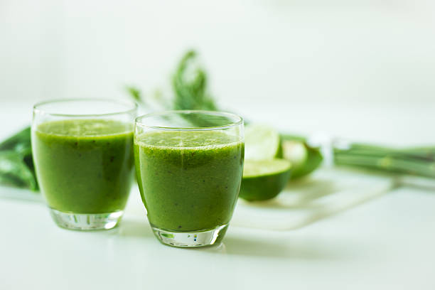 istock Two glasses of green smoothie with fruit and vegetables 180835090