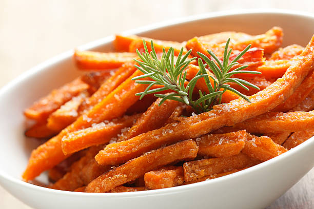 Sweet Potato Fries Close up of a bowl of sweet potato fries, sweet potato french fries stock pictures, royalty-free photos & images