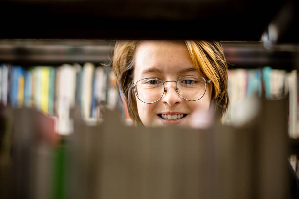 istock Literary Wonderland: Teen's Radiant Expression Amidst a World of Books 1808356015