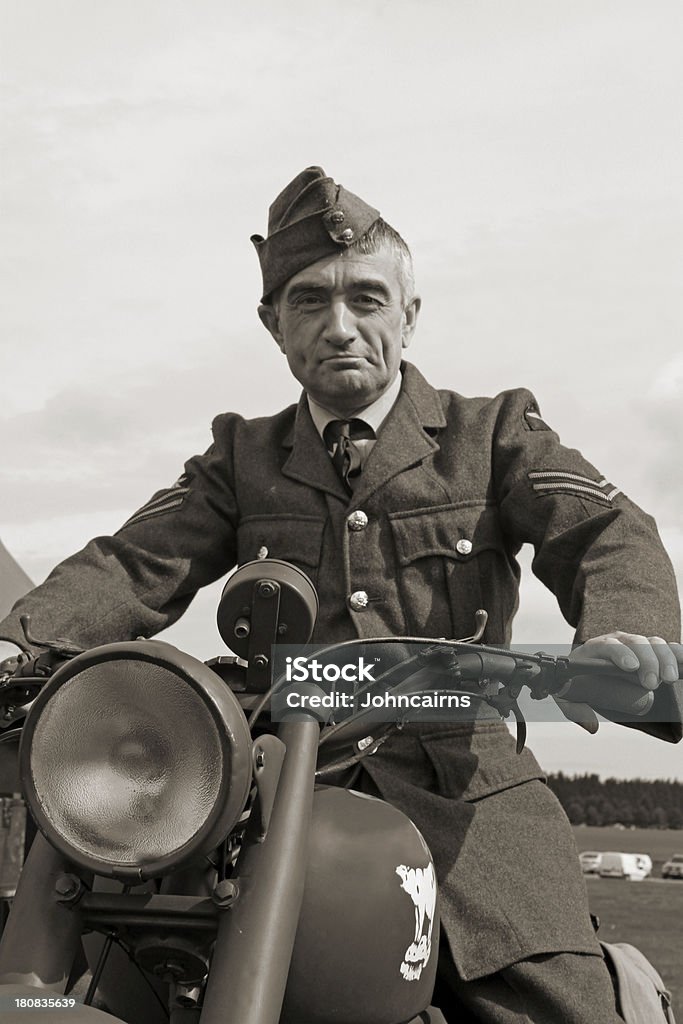 WW2 RAF Ground crew. WW2 RAF Ground crew member on his Motorcycle as used in the Battle of Britain.Picture has been aged to give the feel of a vintage photograph. 1940-1949 Stock Photo