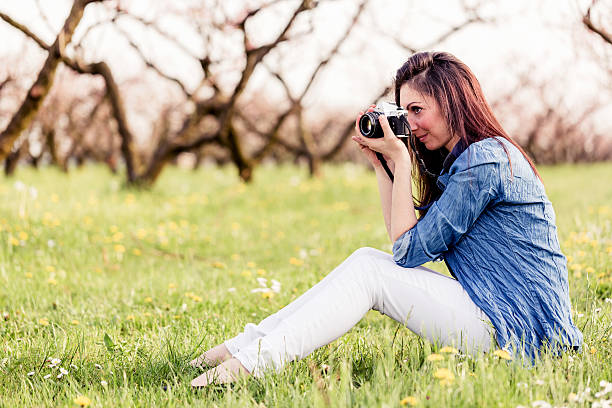 istock Woman taking pictures in a park 180835944