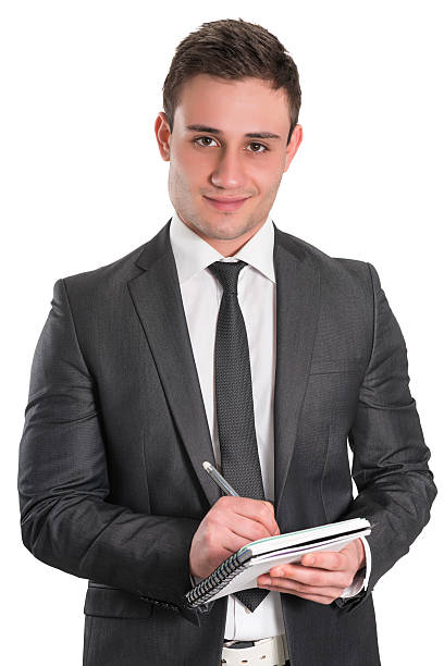 istock Young Handsome and Confident Businessman Writing on Notebook 180835947