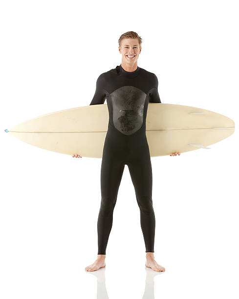 istock Smiling male surfer standing with a surfboard 180836111