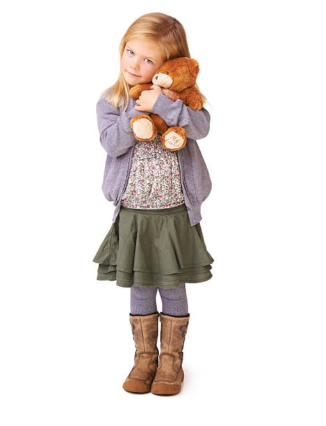 Adorable happy little girl wearing privater school uniform with a school bag, close up photo with copy space, back to schooll. Warm september fall day. Smart clever intellegent little girl.