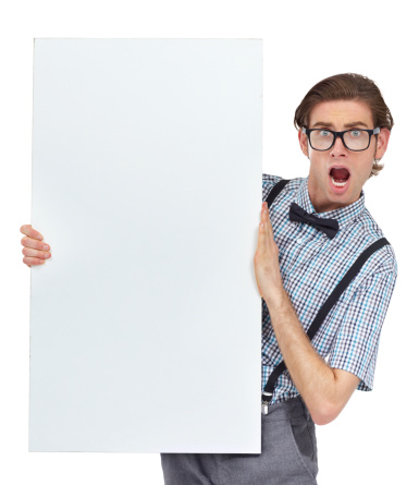 Portrait of a young man looking shocked by the unbelievable sign he's holding