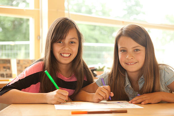 istock Young Schoolgirls Drawing In Art Class 180836958