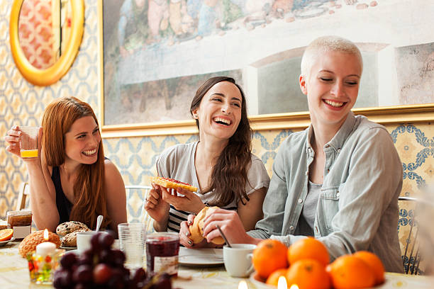 Roommates enjoying a meal together stock photo