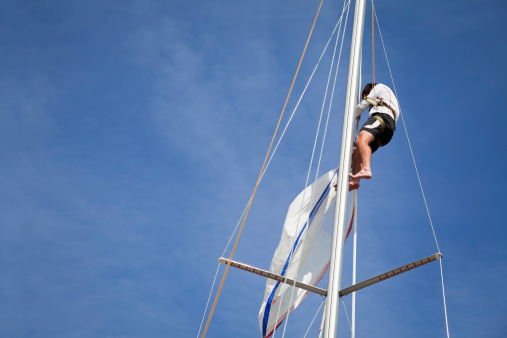 Sailor repairing on sail