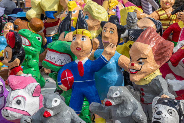 Cuenca, Ecuador - December 29, 2022: Paper mache dolls or Monigotes depicting different heroes and characters for sale in a street market to be burn out  at midnight to celebrate New Year