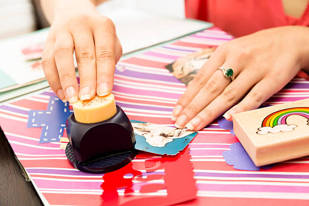 istock Art and Craft: Using punch to Cut out shapes. Scrapbooking. 180837294