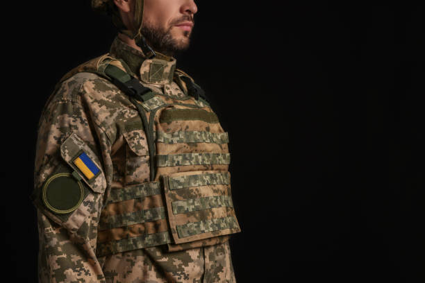 istock Soldier in Ukrainian military uniform on black background, closeup. Space for text 1808383085