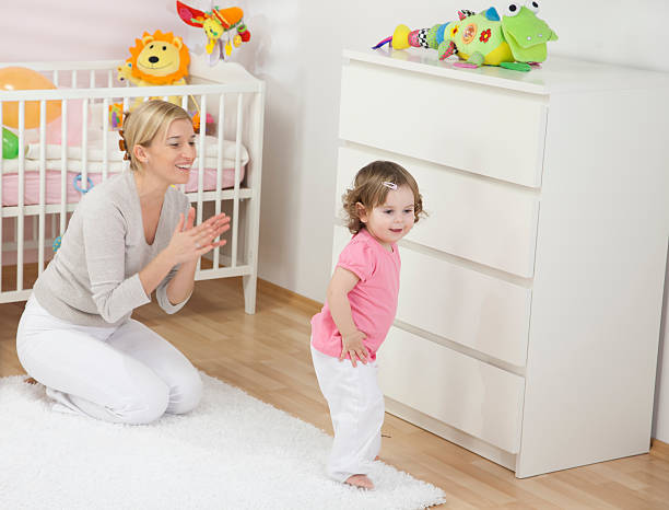 Mother Clapping To Her Dancing Daughter stock photo