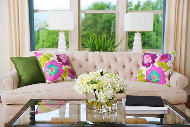 interior view of flower and pottery vase on white table in living room.