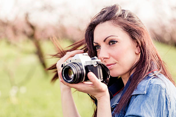 istock Woman taking pictures in a park 180838720