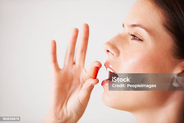 Taking A Vitamin Supplement Stock Photo - Download Image Now - Taking Medicine, Taking Pills, Adult