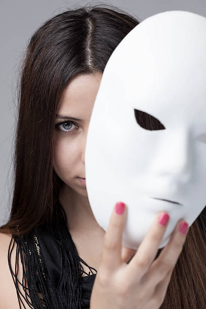 istock Woman peeking behind mask 180838922