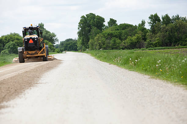 istock Grader Smoothing Gravel Road 180840367